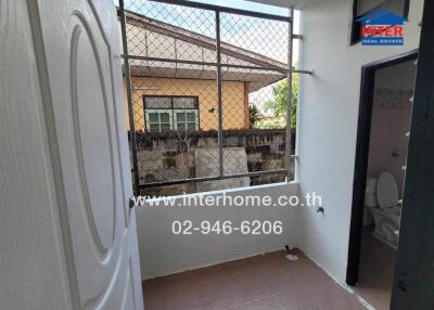 Bathroom view with window and partially open door