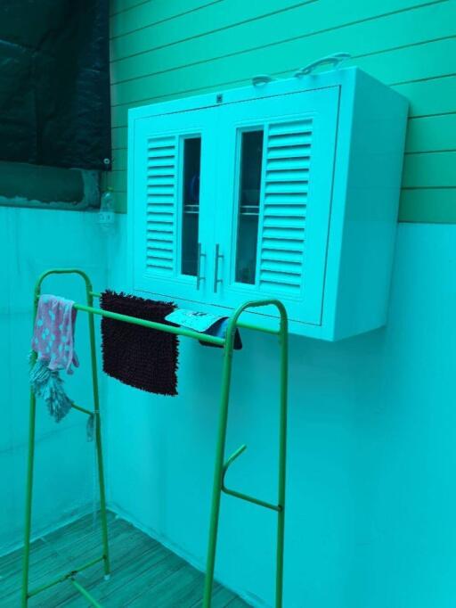 Laundry area with storage cabinet and drying rack