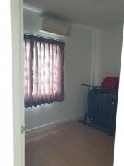 Small bedroom with window and air conditioning unit