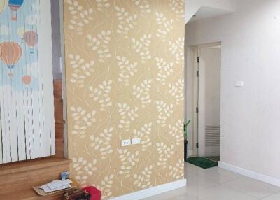 Hallway with decorative wall, steps, and a partially visible mural