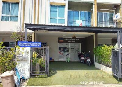 Front view of a multi-story residential building with a gated entrance