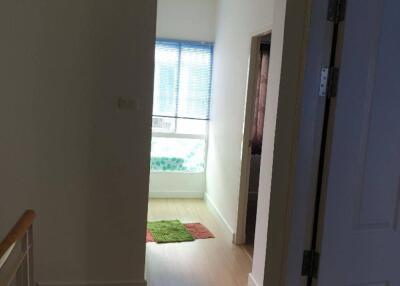 Bright hallway with wooden flooring and window