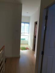 Bright hallway with wooden flooring and window