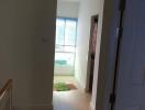 Bright hallway with wooden flooring and window