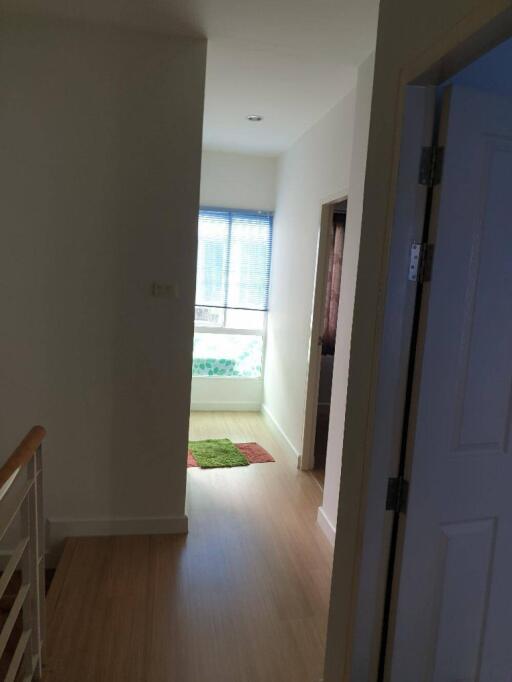 Bright hallway with wooden flooring and window