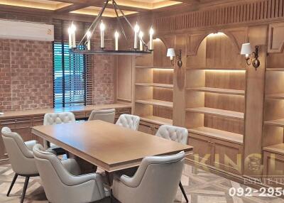 Elegant dining room with built-in bookshelves and modern lighting