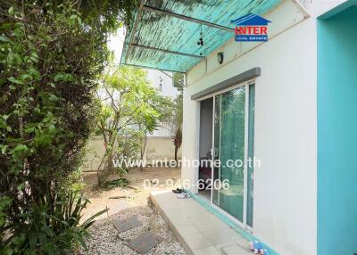 Outdoor area with sliding glass door and greenery