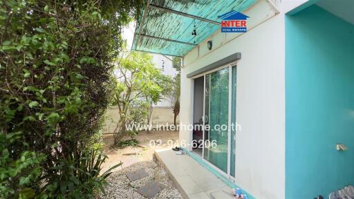 Outdoor area with sliding glass door and greenery