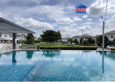 Community swimming pool with houses in the background