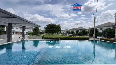 Community swimming pool with houses in the background