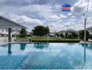 Community swimming pool with houses in the background