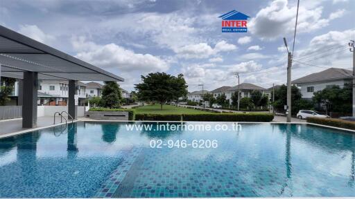 Community swimming pool with houses in the background