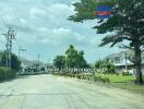 Suburban neighborhood street with houses and greenery