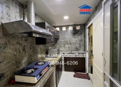 Modern kitchen with stainless steel appliances and marble walls