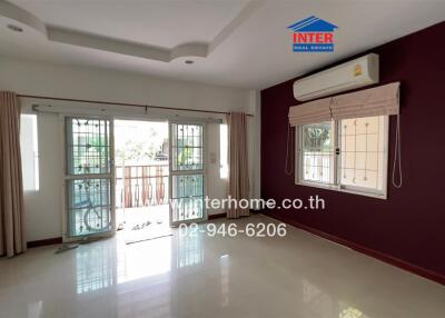 Modern living room with large windows and air conditioning unit