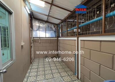 Utility room with tile flooring, wire mesh, and roof covering