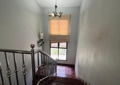 Indoor staircase with wooden steps and a chandelier