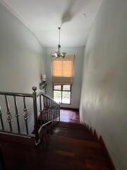 Indoor staircase with wooden steps and a chandelier