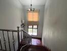 Indoor staircase with wooden steps and a chandelier