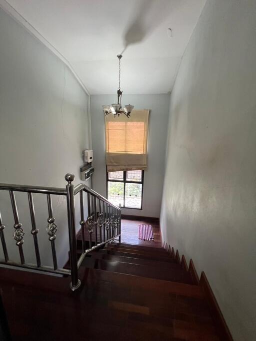 Indoor staircase with wooden steps and a chandelier