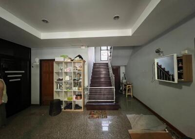 Living room with staircase and storage unit