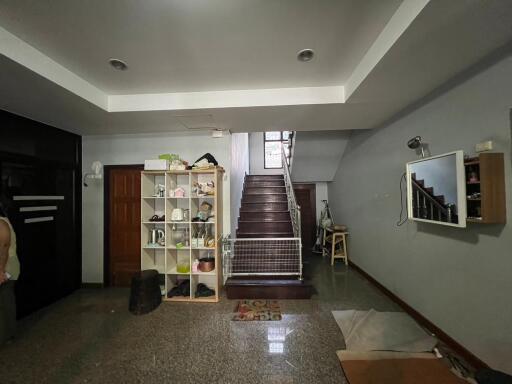 Living room with staircase and storage unit