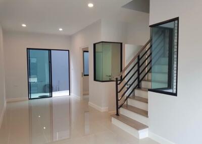 Modern living room with staircase and large windows