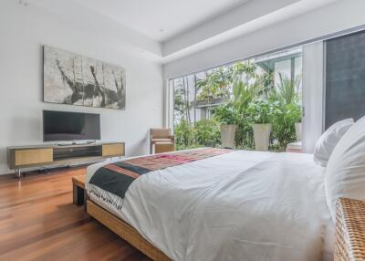 Bright bedroom with large window and modern decor