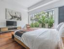 Bright bedroom with large window and modern decor