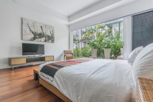 Bright bedroom with large window and modern decor