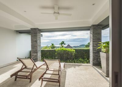 Spacious balcony with lounge chairs and a view