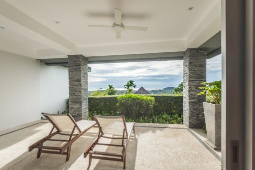 Spacious balcony with lounge chairs and a view