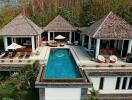 Aerial view of a luxurious villa with a pool and multiple outdoor seating areas