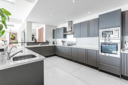 Modern kitchen with sleek gray cabinetry and stainless steel appliances