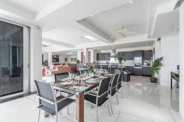 Modern open-concept kitchen and dining area with a spacious layout and contemporary furnishings.