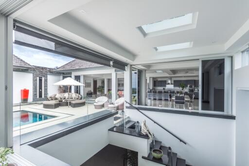 Spacious modern main living area with view of the pool and outdoor seating