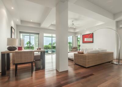 Modern living area with large windows and wooden flooring