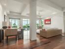 Modern living area with large windows and wooden flooring