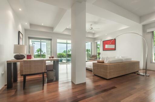 Modern living area with large windows and wooden flooring