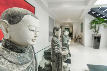 Hallway with statues and modern decor