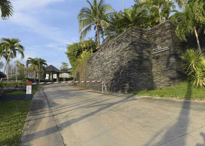 Gated entrance with lush landscaping