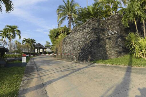 Gated entrance with lush landscaping