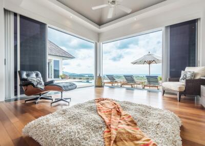 Spacious living area with a view of the outdoor patio and pool