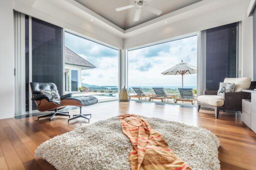 Spacious living area with a view of the outdoor patio and pool