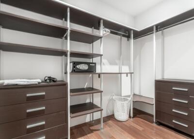 Spacious walk-in closet with shelving and storage options