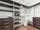 Spacious walk-in closet with shelving and storage options