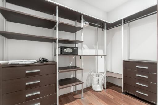 Spacious walk-in closet with shelving and storage options