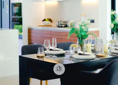 Modern dining area with table setting and green plants