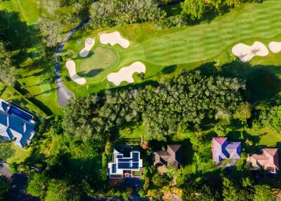 Aerial view of residential properties near a golf course