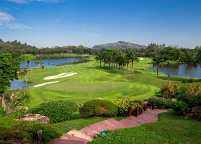 Scenic view of a lush green golf course with well-maintained landscaping